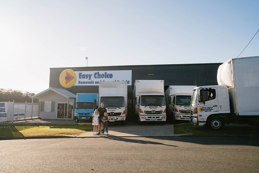 People Stand in Front of Easy Choice Moving Trucks — Easy Choice Removals and General Freight In Port Macquarie, NSW