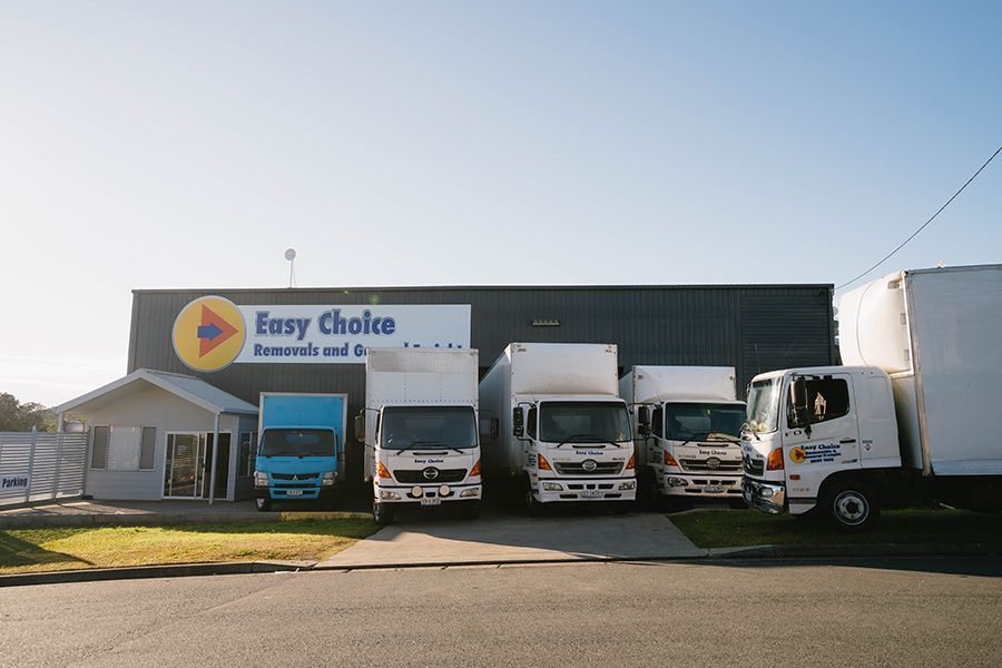 A Row of White Moving Trucks — Easy Choice Removals and General Freight In Port Macquarie, NSW