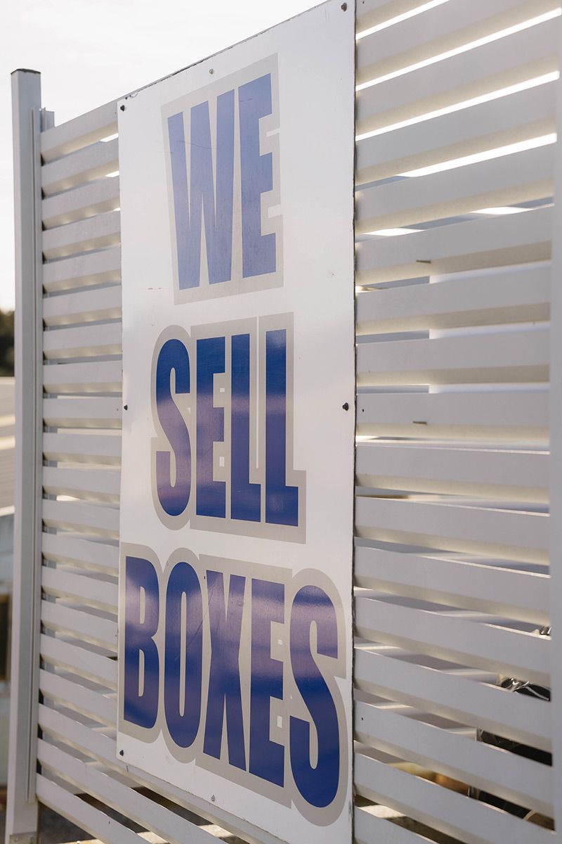Sign On The Fence That Says We Sell Boxes — Easy Choice Removals and General Freight In Goulburn, NSW