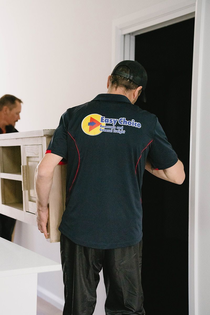 Movers Carrying Furniture Through A Doorway — Easy Choice Removals and General Freight In Mid North Coast, NSW