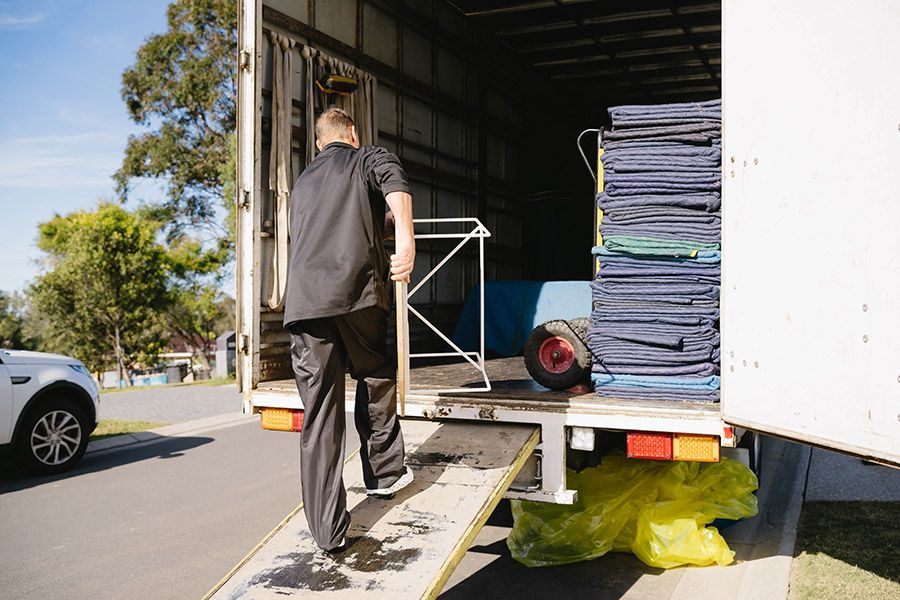 Man Loading a Truck — Easy Choice Removals and General Freight In Port Macquarie, NSW