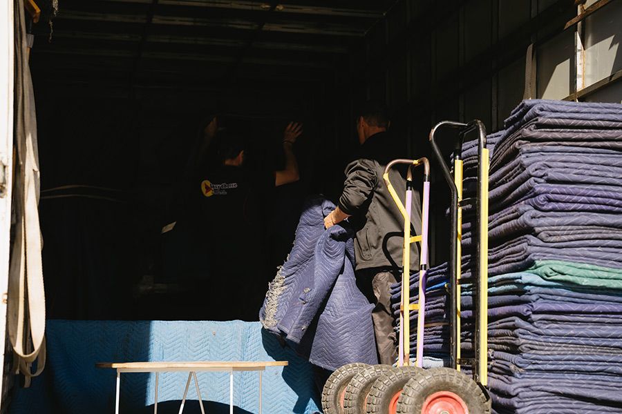 Movers Loading Truck With Moving Blankets and a Dolly — Easy Choice Removals and General Freight In Port Macquarie, NSW