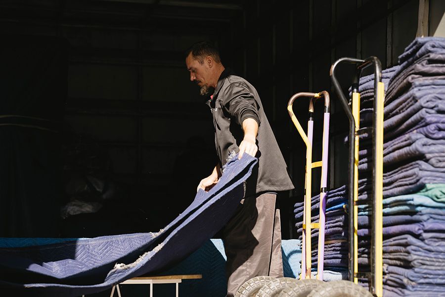 Man Loading Furniture Into A Storage Unit — Easy Choice Removals and General Freight In Port Macquarie, NSW