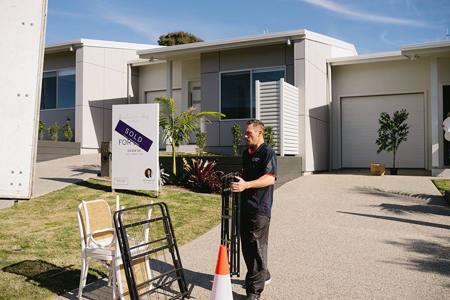 Man Stands in Front of Modern Houses — Easy Choice Removals and General Freight In Port Macquarie, NSW