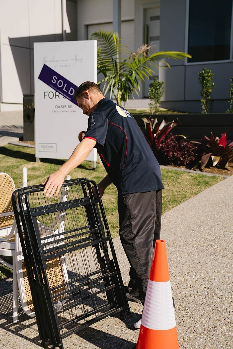 Man Stacking Chairs — Easy Choice Removals and General Freight In Port Macquarie, NSW