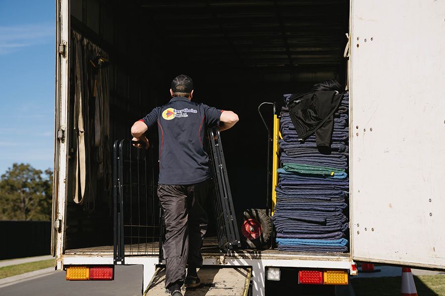 Person Loading A Moving Truck With A Black Metal Frame — Easy Choice Removals and General Freight In Port Macquarie, NSW