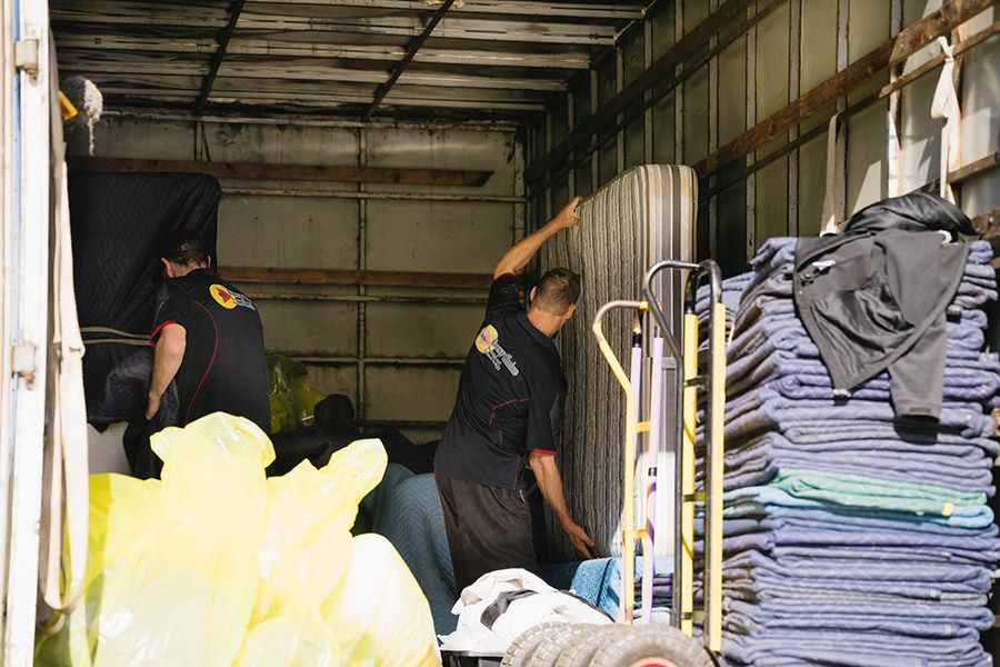 Two Movers Loading A Mattress Into A Moving Truck — Easy Choice Removals and General Freight In Greater Sydney, NSW