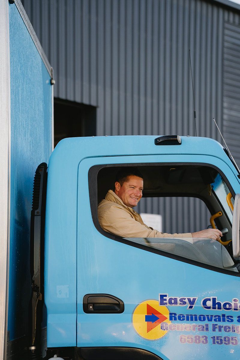 Man Driving a Blue Truck — Easy Choice Removals and General Freight in Ballina, NSW