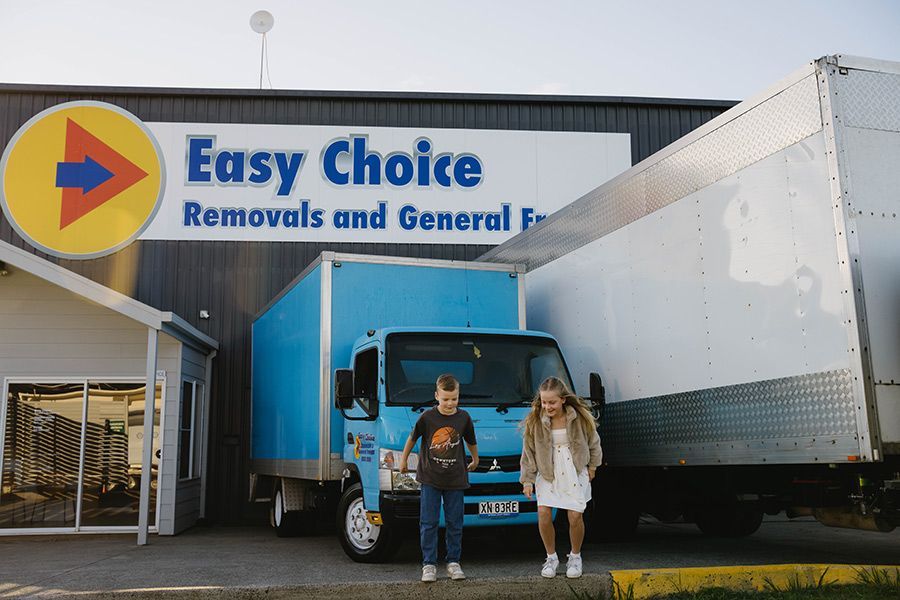 Two children stand in front of Easy Choice Removals — Easy Choice Removals and General Freight In Tweed Heads, NSW