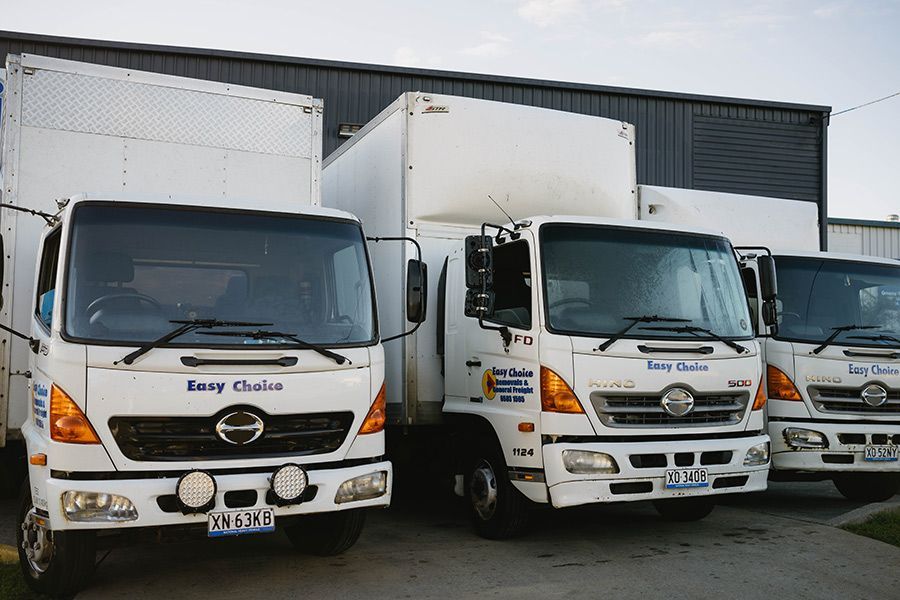 White Easy Choice Moving Trucks Parked Outdoors — Easy Choice Removals and General Freight In Brisbane, QLD