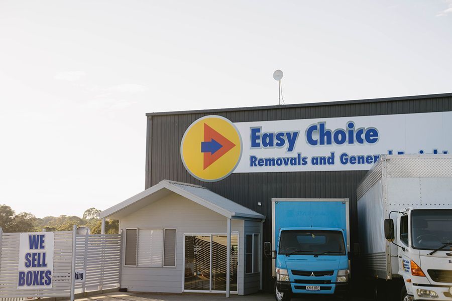 Easy Choice Removals Building with Blue Truck and Sign — Easy Choice Removals and General Freight In Gold Coast, QLD