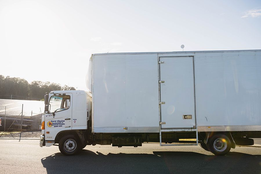 A Moving Truck is Parked in Front of a House — Easy Choice Removals and General Freight in Newcastle, NSW