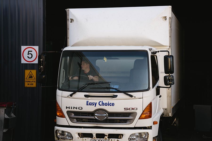 A Pile of Cardboard Boxes Sitting on Top of a Bed — Easy Choice Removals and General Freight In Gold Coast, NSW