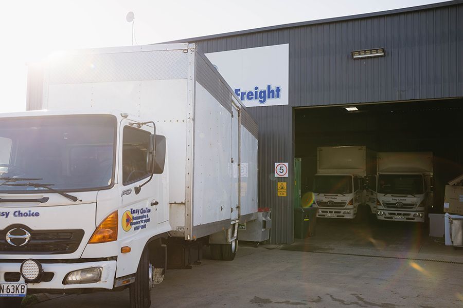 Freight Trucks Parked in Front of a Warehouse, Loading/unloading — Easy Choice Removals and General Freight In Lismore, NSW