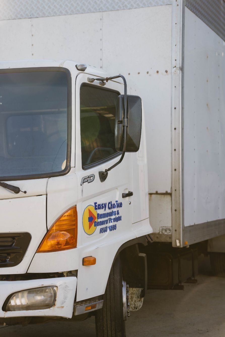 White Delivery Truck With Company Logo on the Side — Easy Choice Removals and General Freight In Port Macquarie, NSW