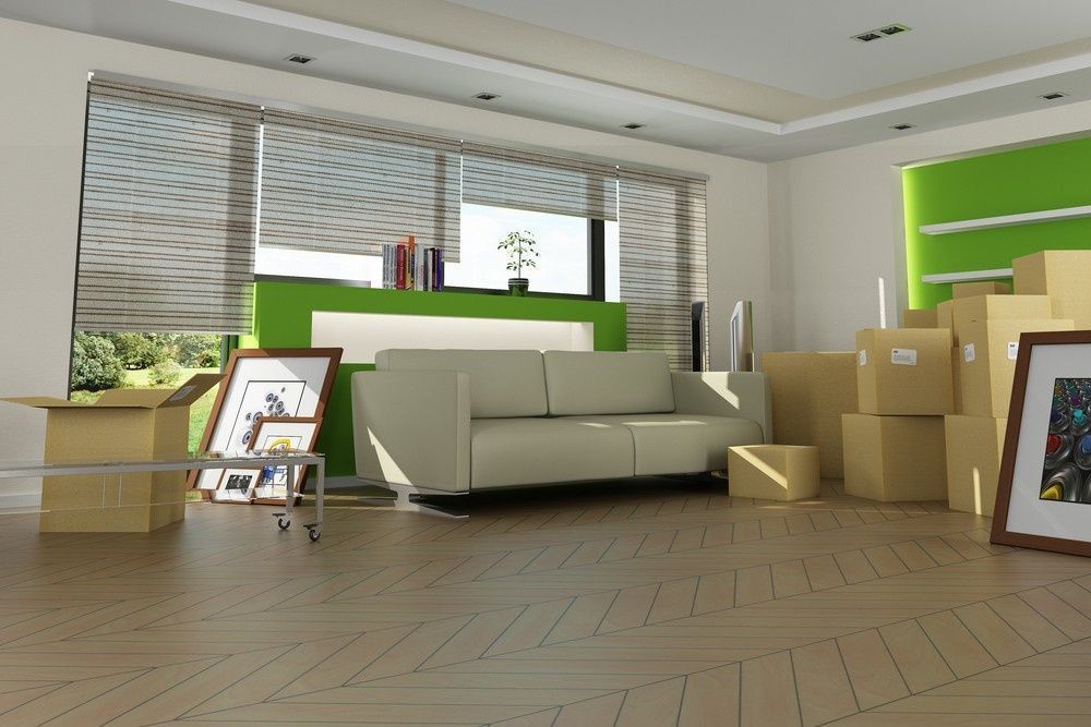 Living Room With Moving Boxes, Sofa, Art, and Open Blinds; Hardwood Floors and Green Accents