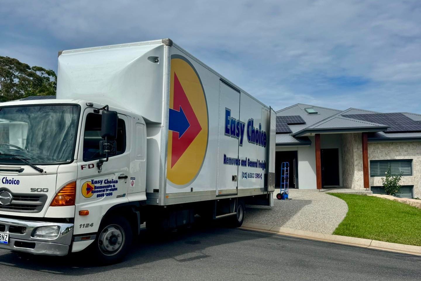 A Professional Removalist Truck Parked Outside A Home
