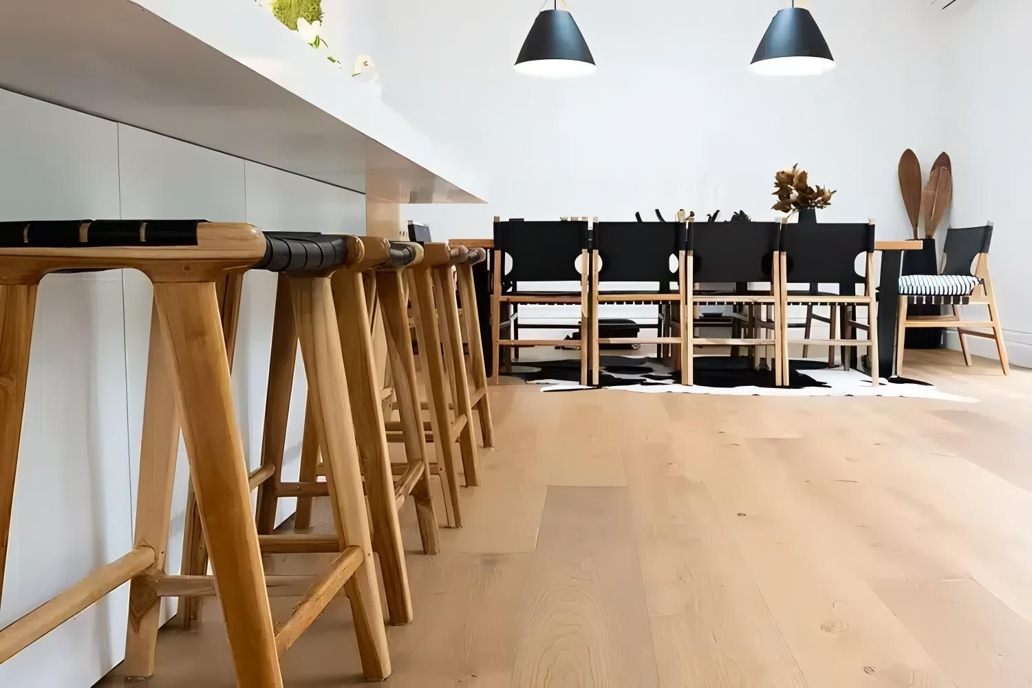 A Row of Wooden Bar Stools Are Lined Up in a Living Room — Easy Choice Removals and General Freight In Port Macquarie, NSW