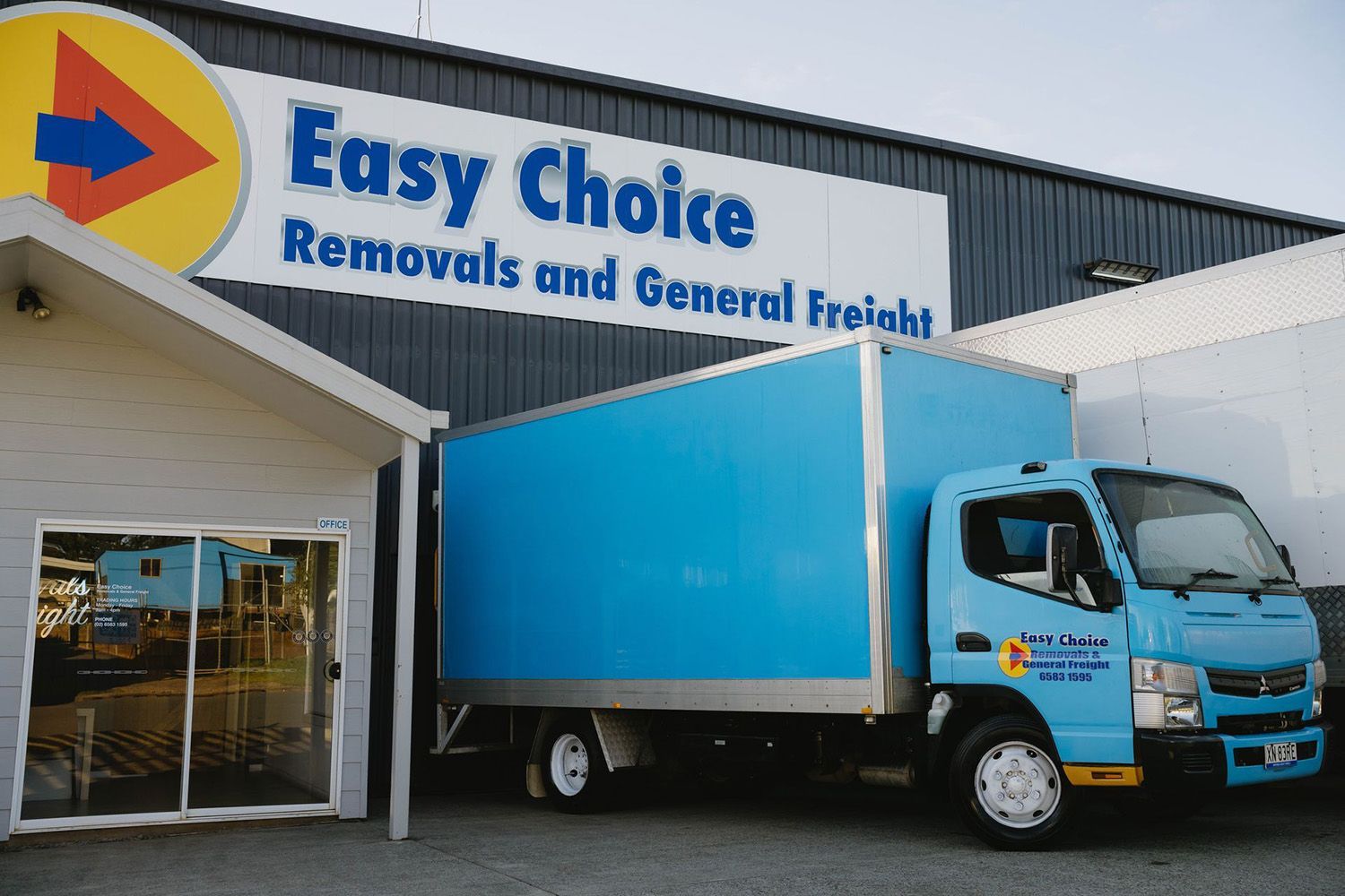 Blue Delivery Truck Parked Outside An 