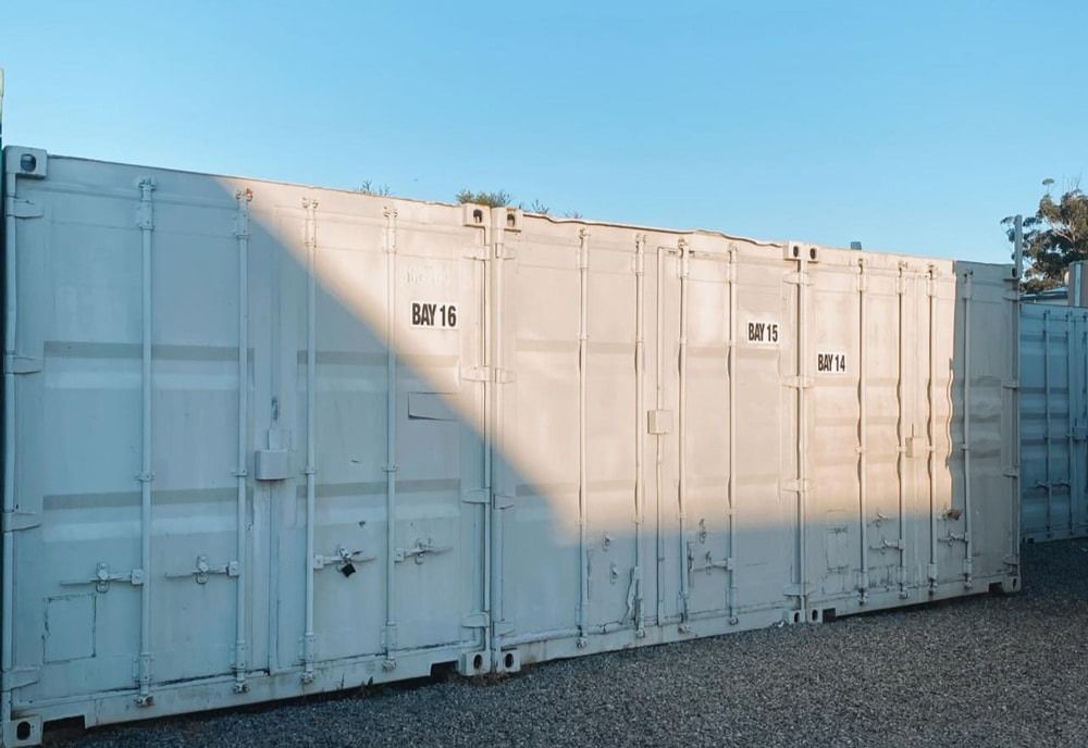 A row of white shipping containers are parked next to each — Easy Choice Removals and General Freight In Port Macquarie, NSW
