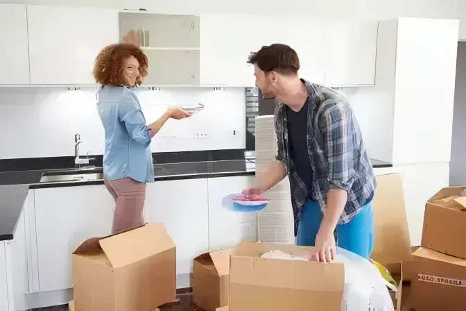 A Man and a Woman Are Packing Boxes in a Kitchen — Easy Choice Removals and General Freight In Port Macquarie, NSW