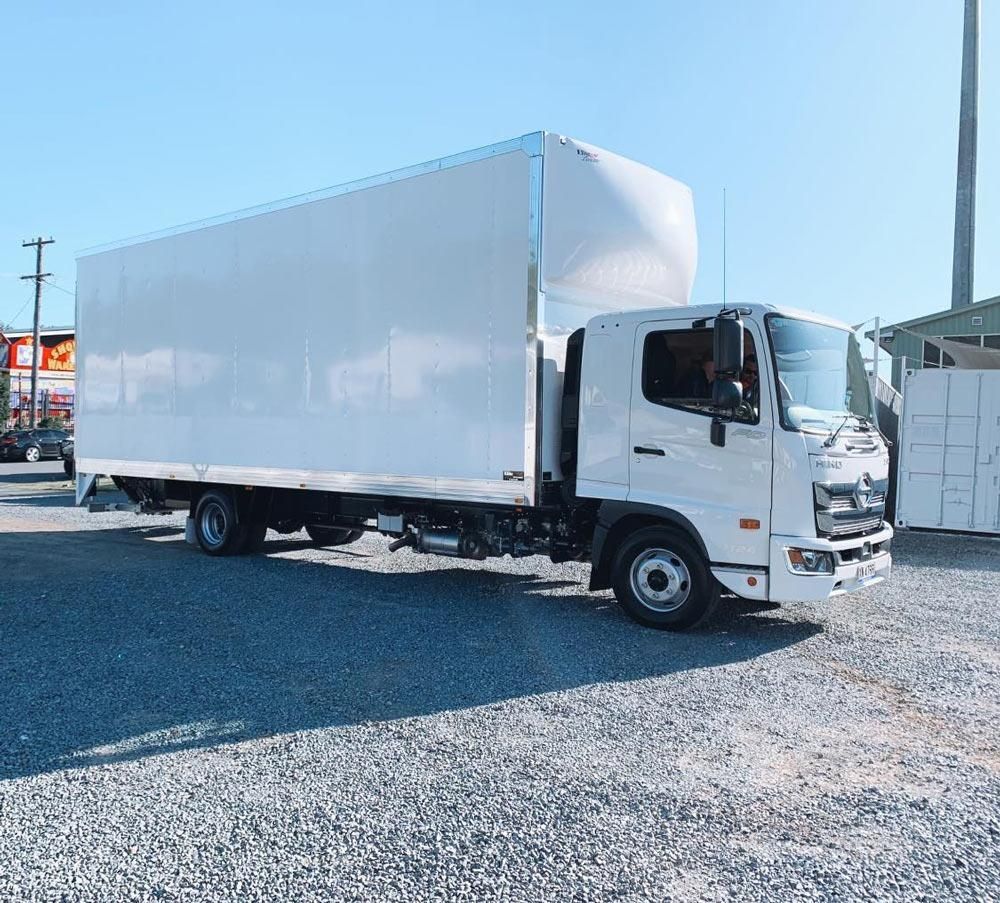 A White Truck is Parked in a Gravel Lot — Easy Choice Removals and General Freight In Port Macquarie, NSW