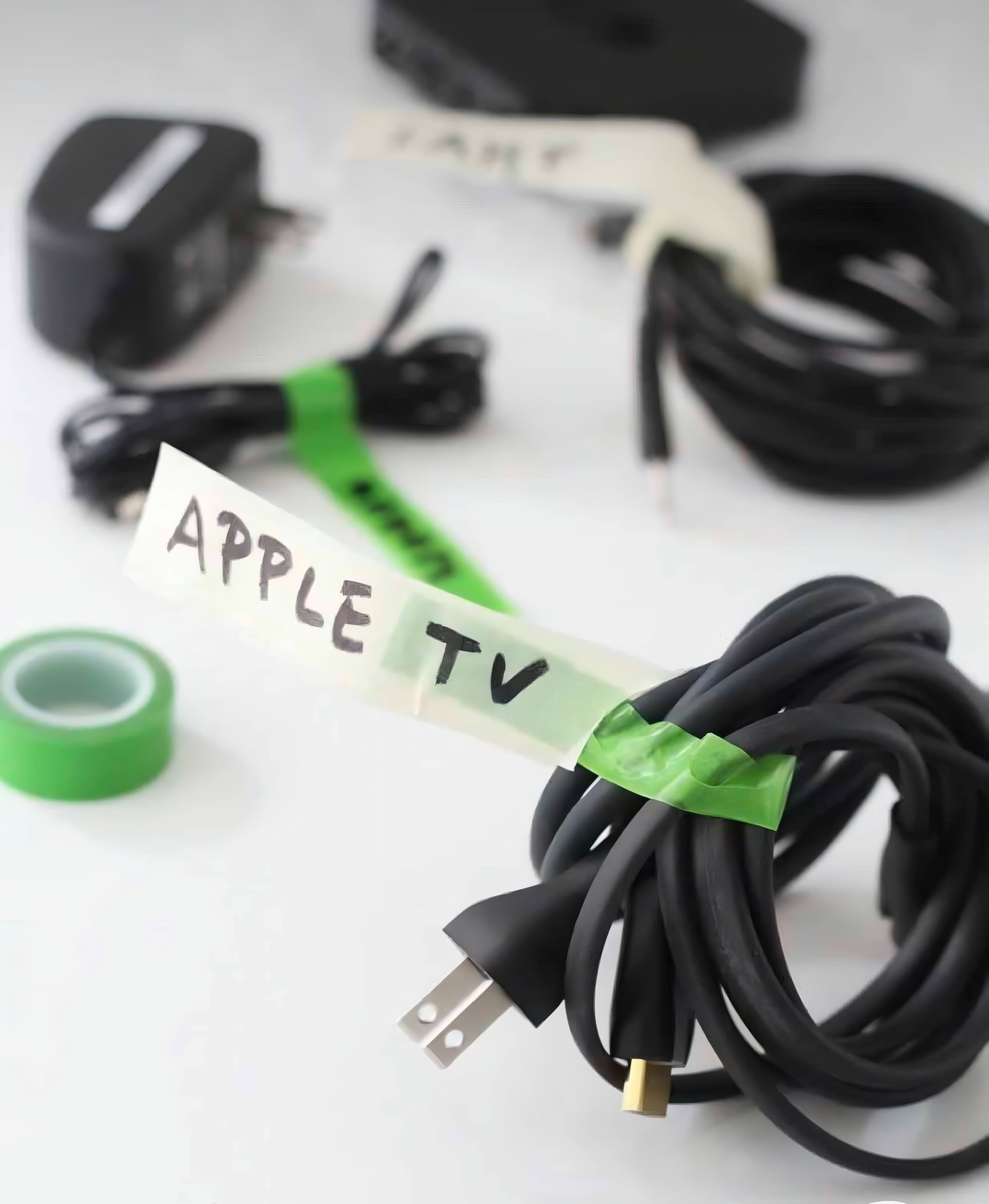 A Bunch of Wires With a Green Tape Labeled Apple Tv — Easy Choice Removals and General Freight In Port Macquarie, NSW