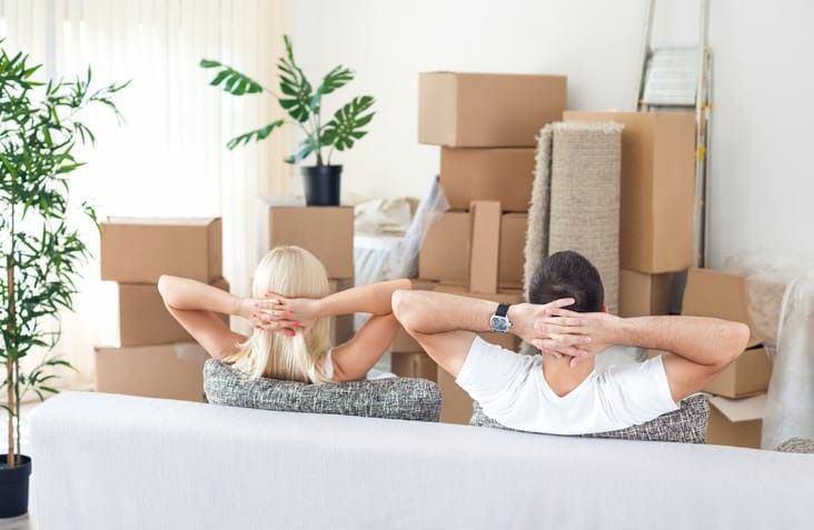 A Man and a Woman Are Sitting on a Couch — Easy Choice Removals and General Freight In Port Macquarie, NSW