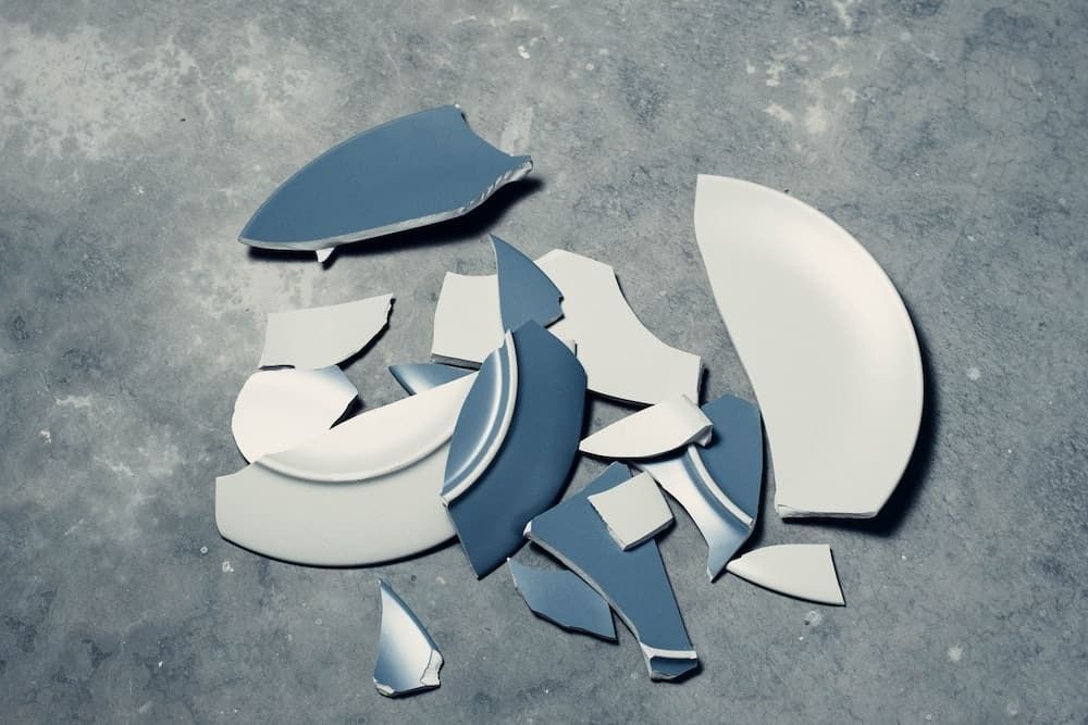 A Broken Plate is Laying on a Concrete Surface — Easy Choice Removals and General Freight In Port Macquarie, NSW