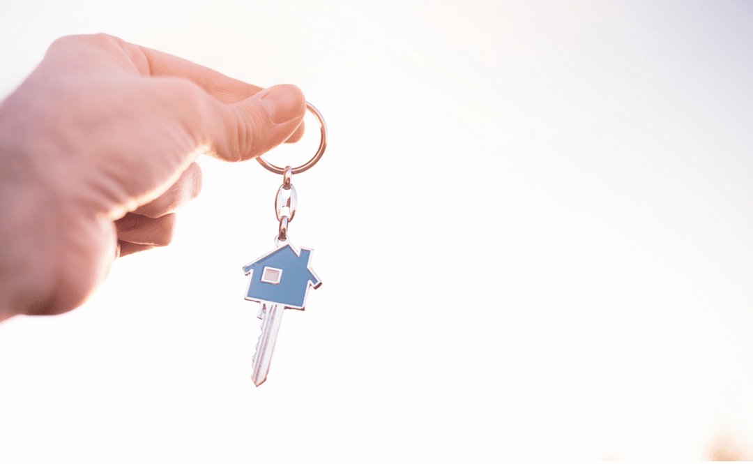 A Person is Holding a House Key on a Keychain — Easy Choice Removals and General Freight In Port Macquarie, NSW