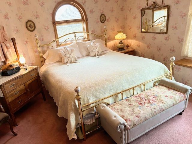 A bedroom with king bed, fireplace, 55