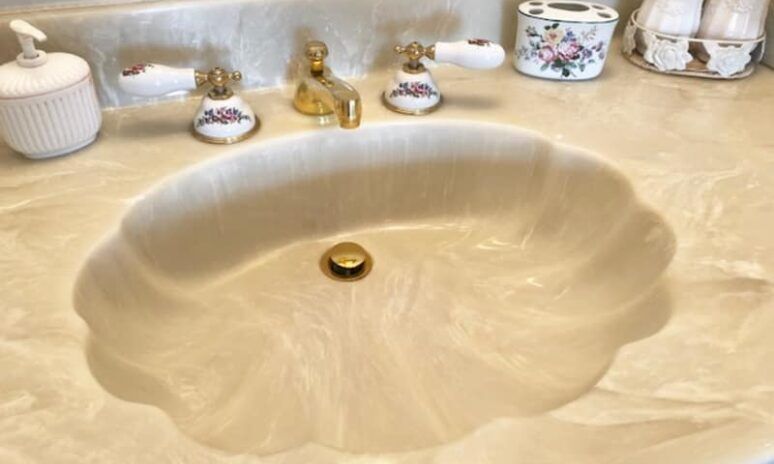A bathroom sink with a faucet and soap dispenser on the counter.