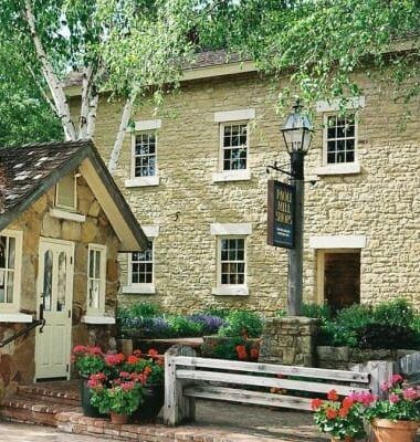 A stone building with a sign that says pub and inn