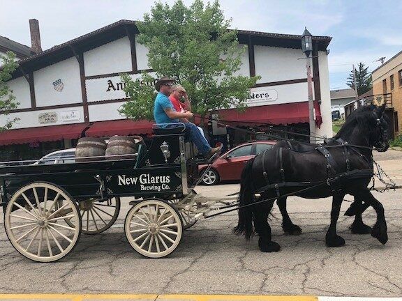 A horse drawn carriage with the word new glorys on it