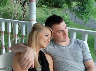 A man and a woman are sitting on a porch.