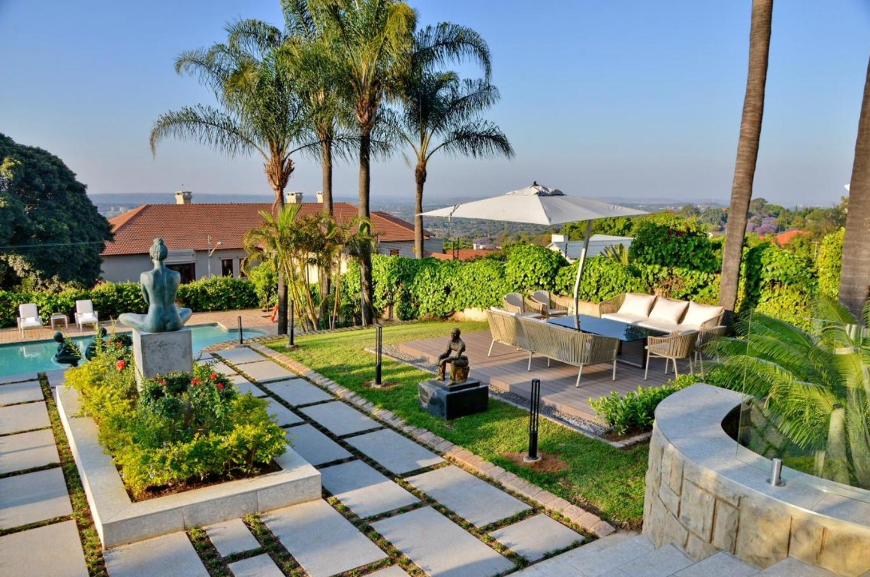 A patio area with a statue and a swimming pool
