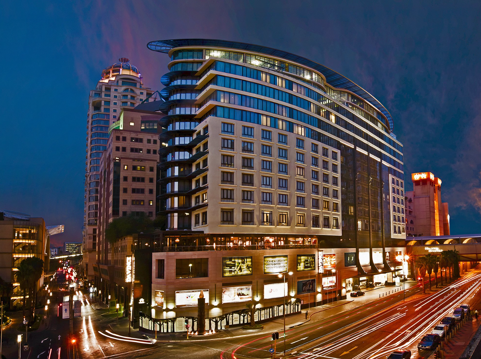 A large building with a lot of windows is lit up at night