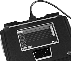 Black device with a small screen and cable attached, showing a simple interface panel. | CB Warren's Auto Care
