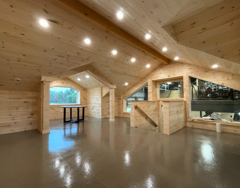 A driveway leading to a house with trees in the background