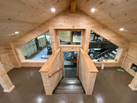 A large concrete structure is being built in a parking lot.