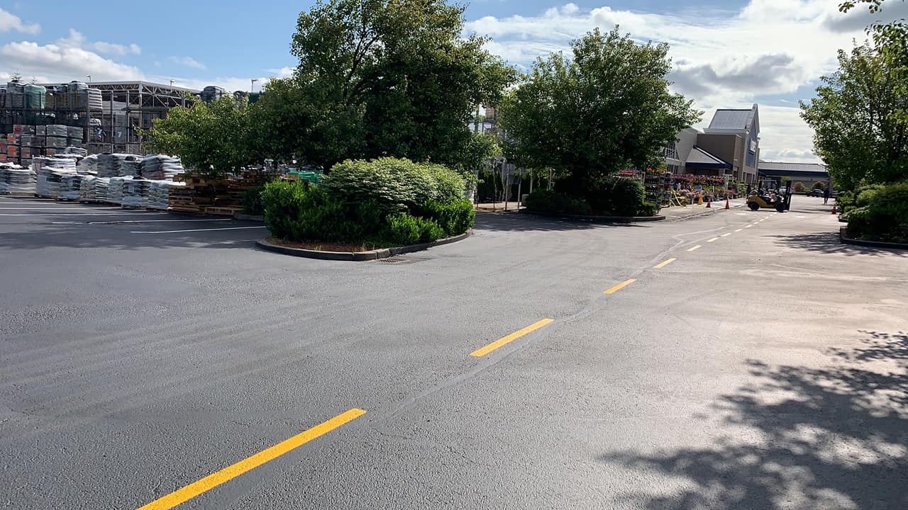 A parking lot with a yellow line on the side of the road.