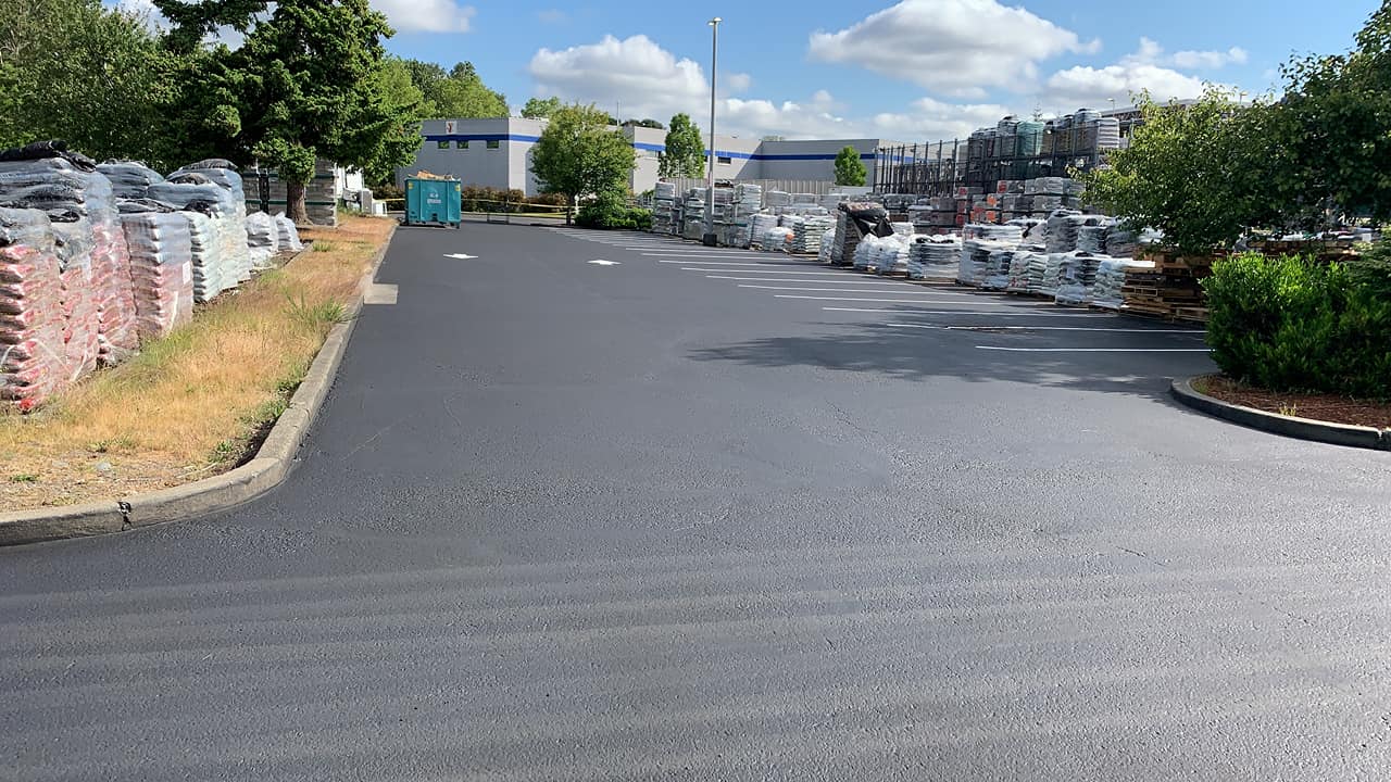 A black asphalt road with a lot of bricks on the side of it.