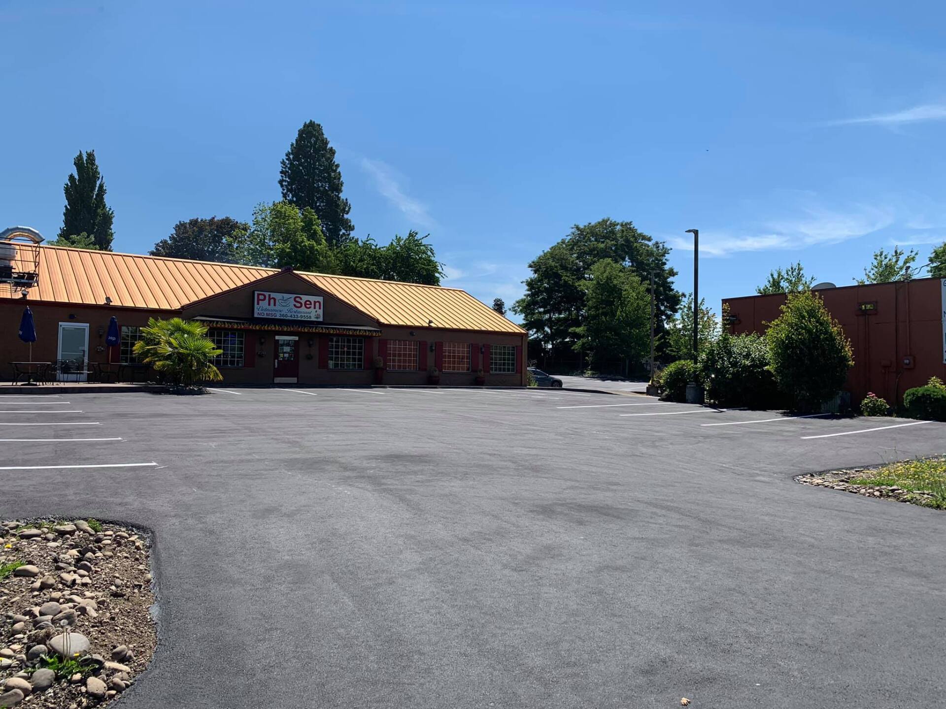 An empty parking lot with a building in the background