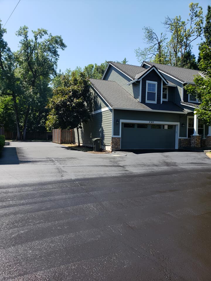 A house with a garage and a driveway in front of it