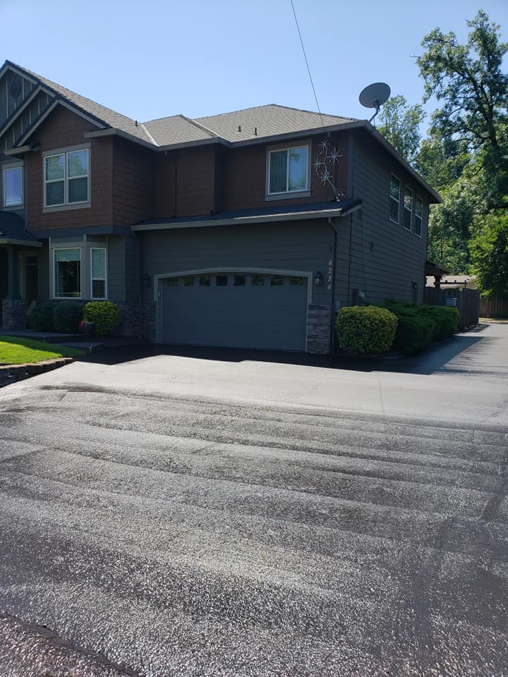 A large house with a satellite dish on the roof and a driveway.