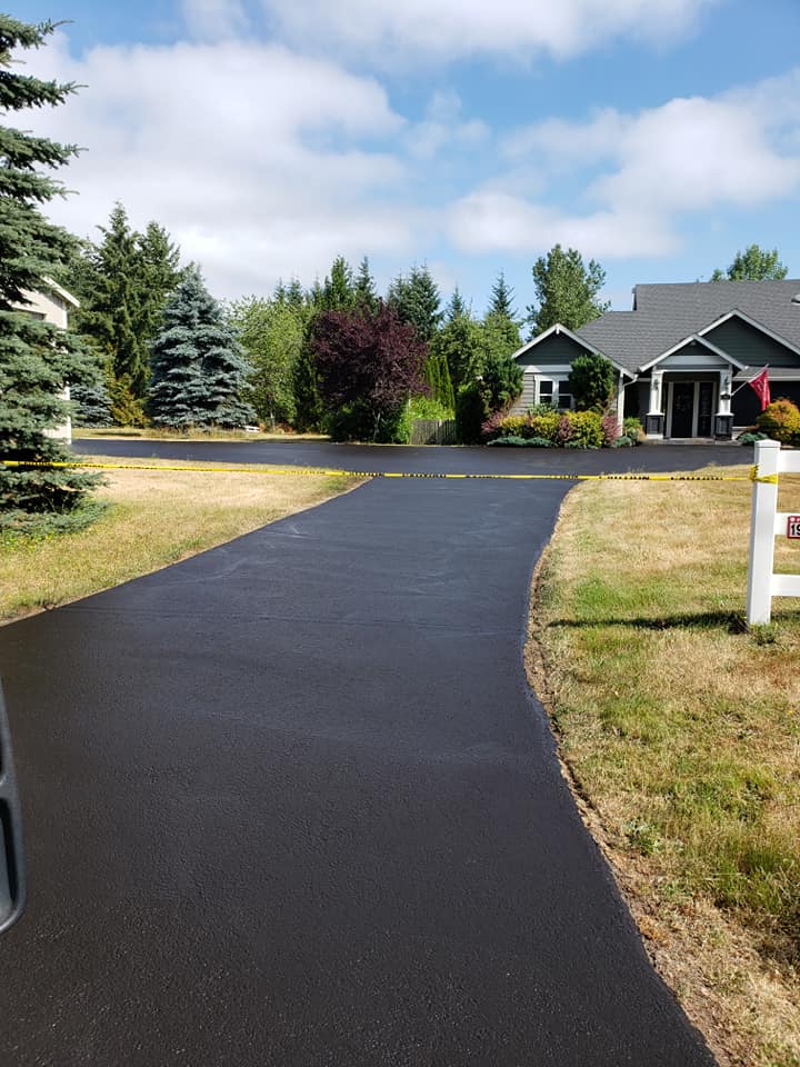 A driveway leading to a house on a sunny day