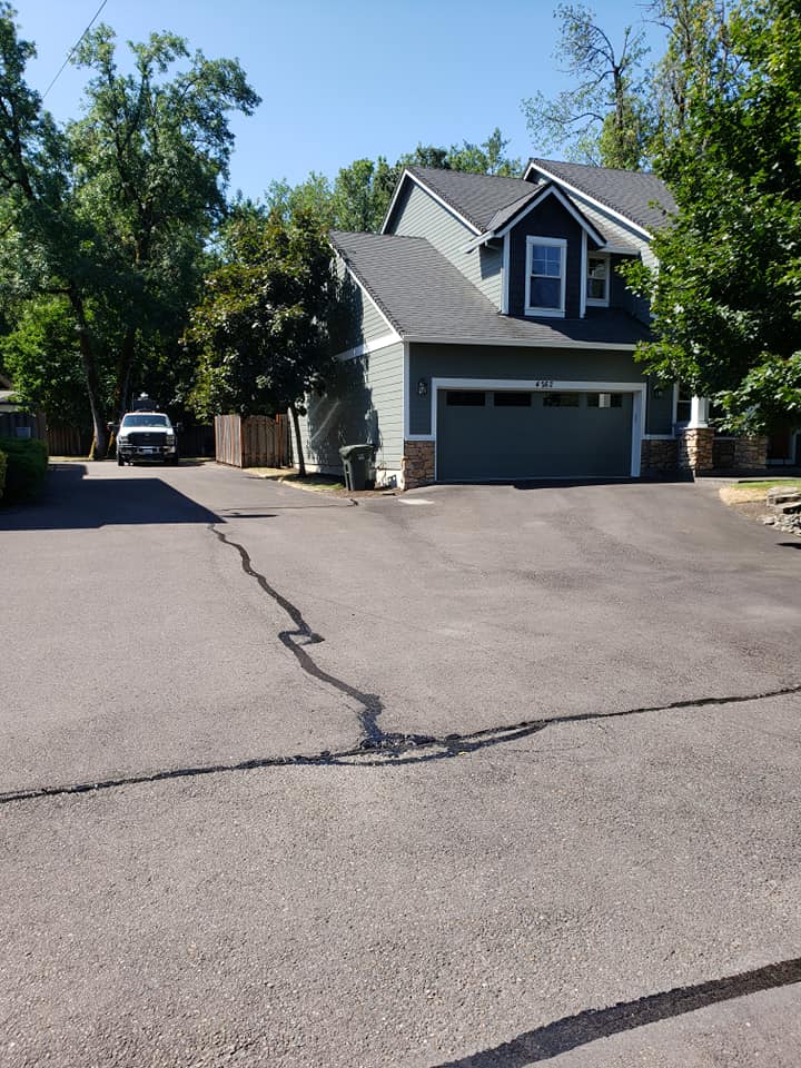 A house with a garage and a car parked in front of it