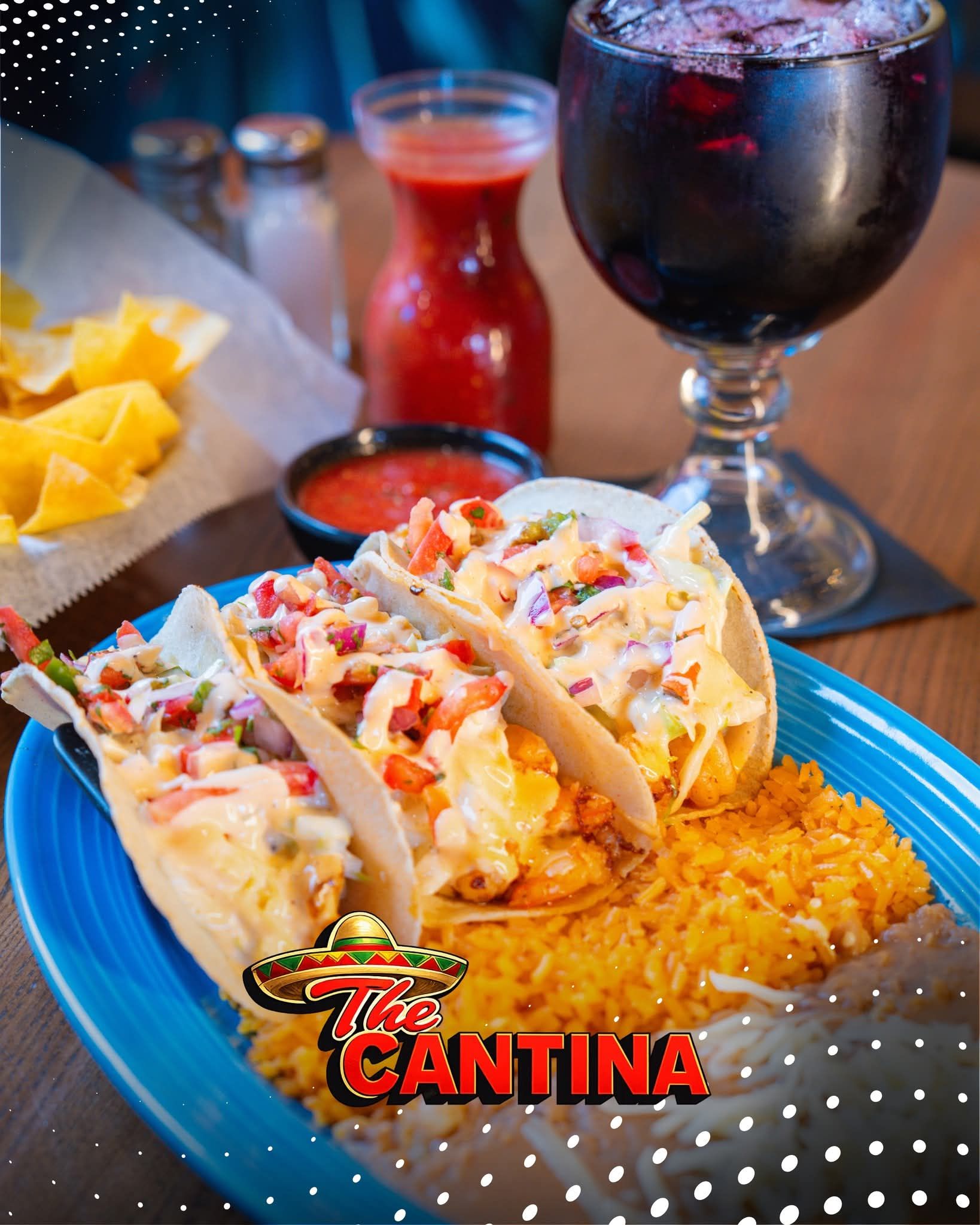 A molten lava rock bowl filled with meat and peppers topped with a skewer, served on a wooden platter at a bar.