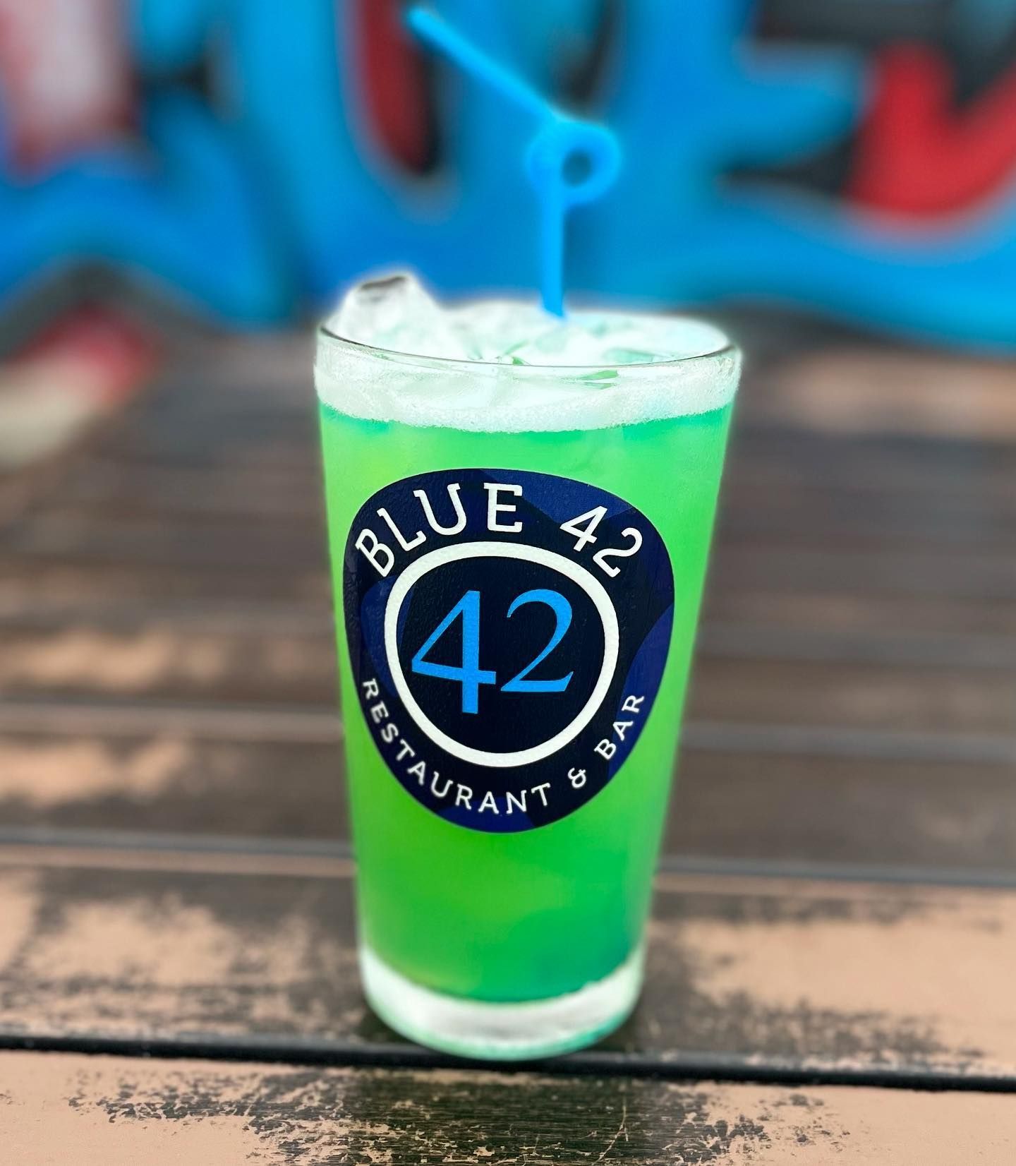 A blue 42 restaurant and bar drink with a straw in it