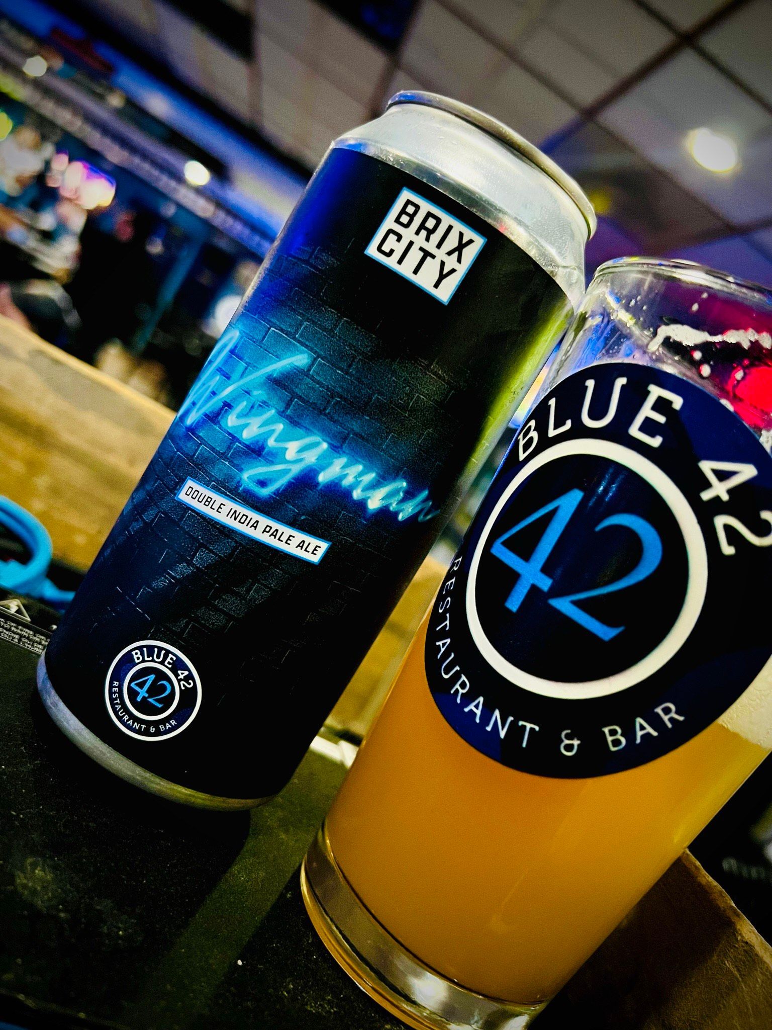 A can of brix city beer next to a glass of beer